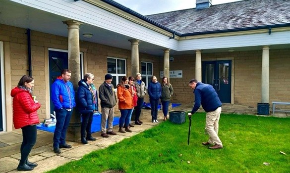 People standing outside in front of a building.